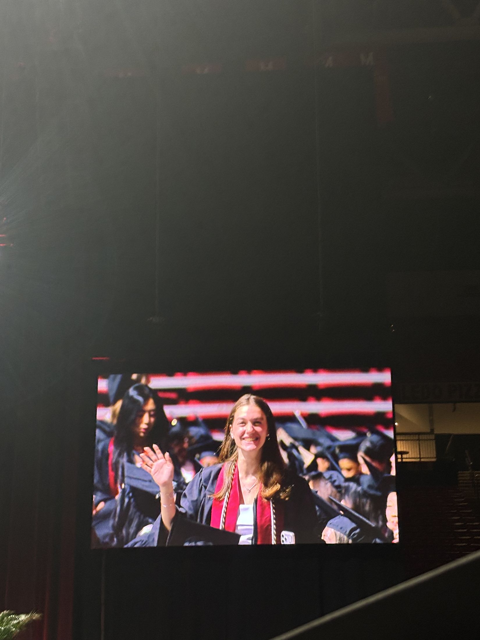 Mira waving at her UMD graduation